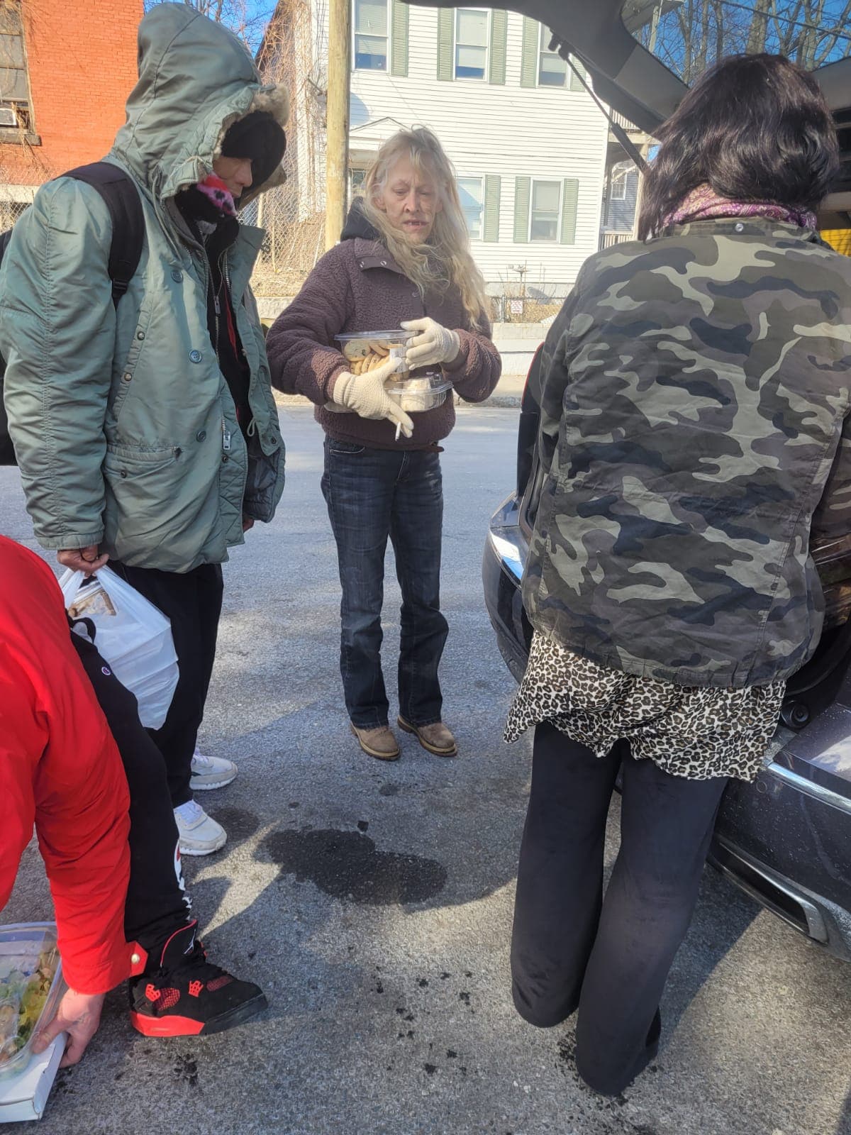 Neighbors receiving prepared food during HESM street outreach