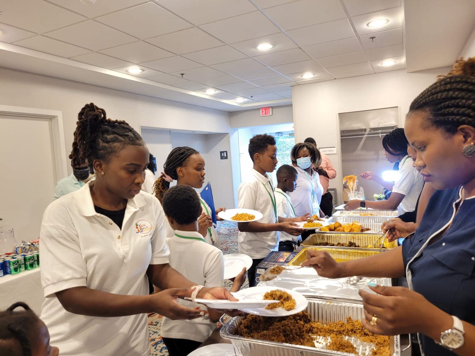 Volunteers and children gathered around a shared meal