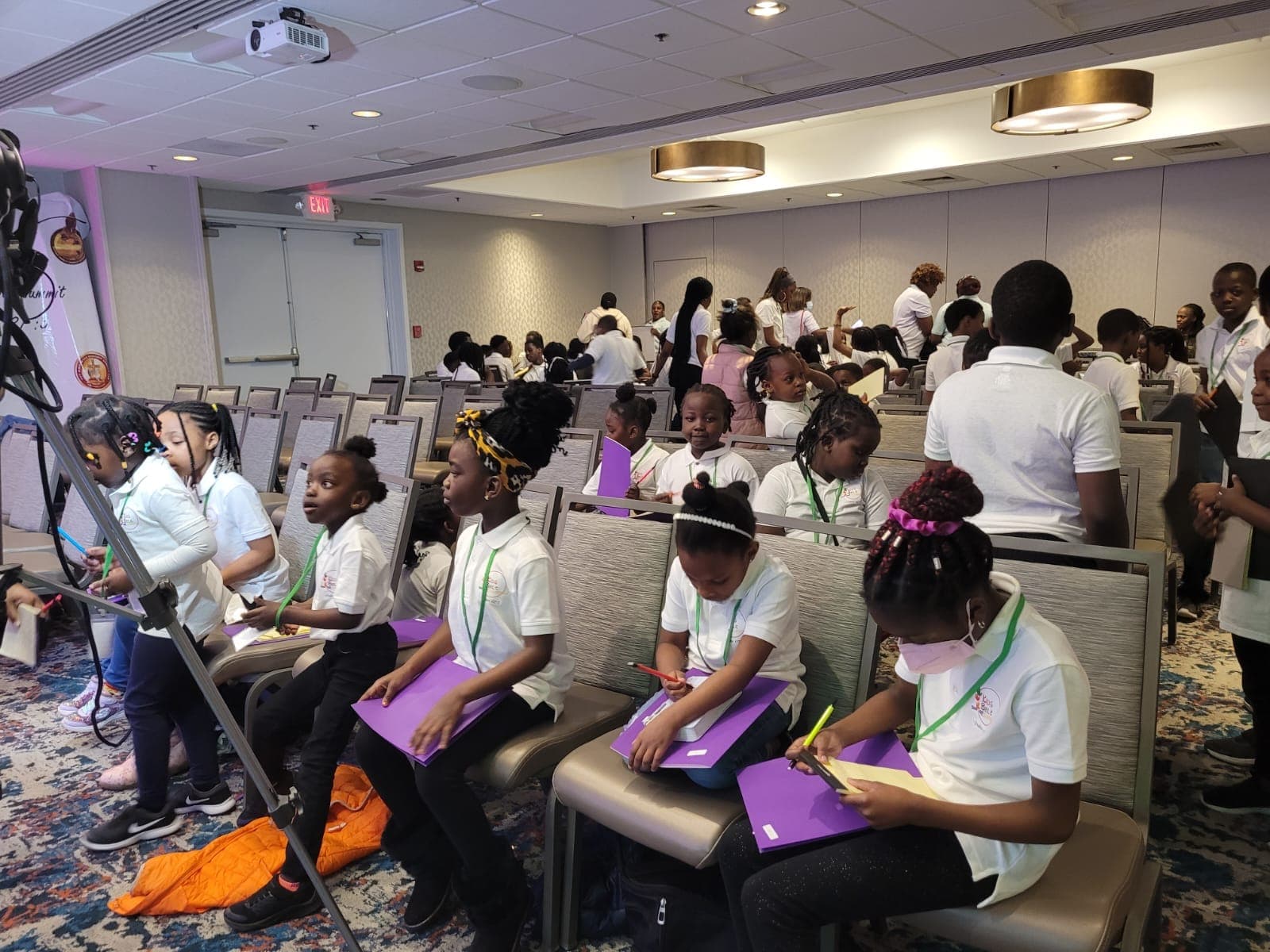 Children working with folders and pencils during a youth workshop